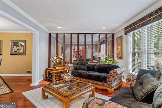 living room with wood-type flooring and crown molding