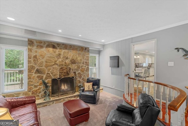 living room featuring crown molding and a fireplace