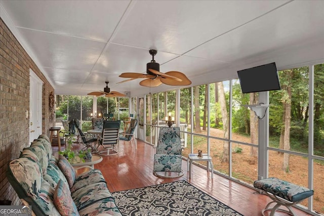 sunroom / solarium featuring ceiling fan