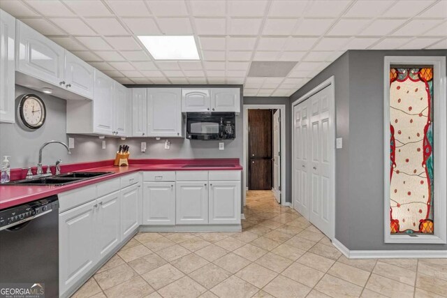 kitchen with white cabinetry, sink, and black appliances