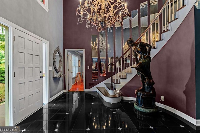 entrance foyer featuring a towering ceiling and a notable chandelier