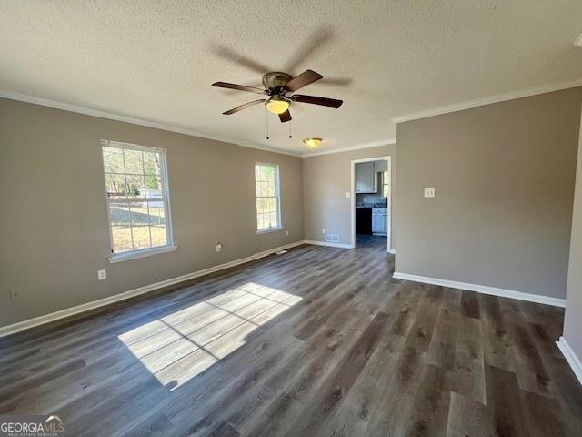 unfurnished room with crown molding, dark hardwood / wood-style flooring, ceiling fan, and a textured ceiling