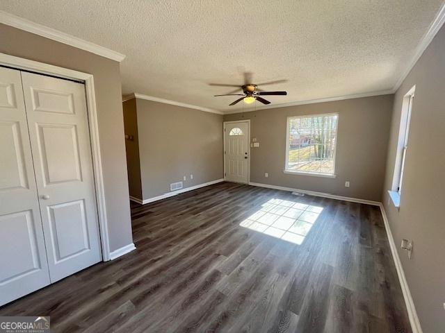 interior space with a textured ceiling, crown molding, ceiling fan, and dark hardwood / wood-style floors