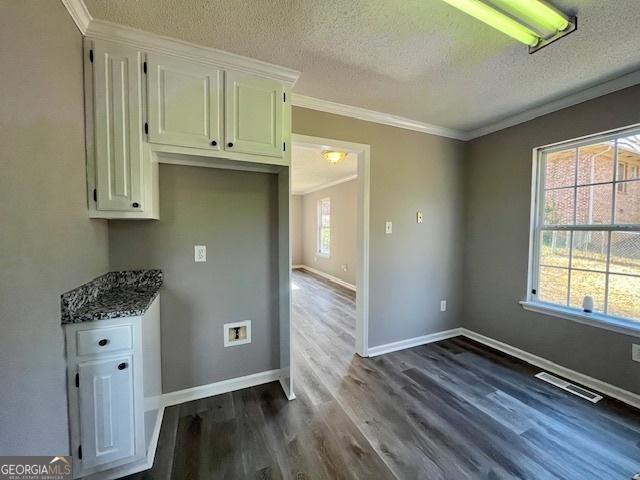 kitchen featuring plenty of natural light, hardwood / wood-style floors, and ornamental molding