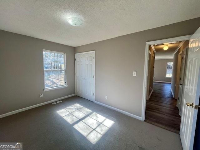 unfurnished bedroom with a closet and a textured ceiling