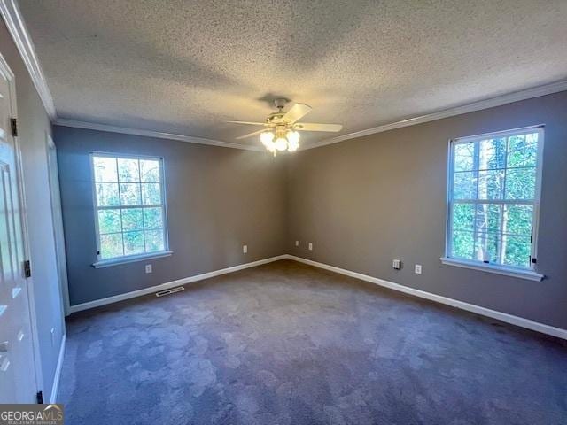 carpeted empty room featuring ceiling fan, a healthy amount of sunlight, a textured ceiling, and ornamental molding