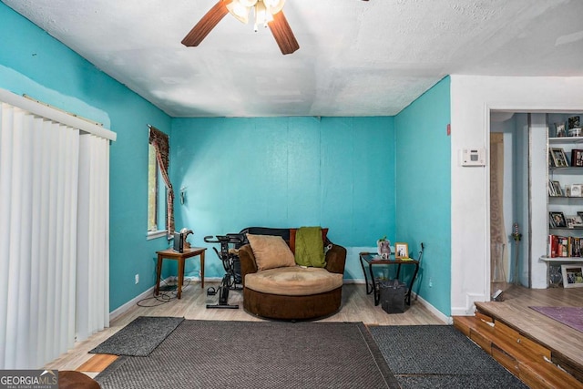 sitting room featuring light hardwood / wood-style flooring and ceiling fan