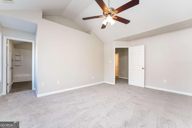 carpeted spare room with vaulted ceiling and ceiling fan