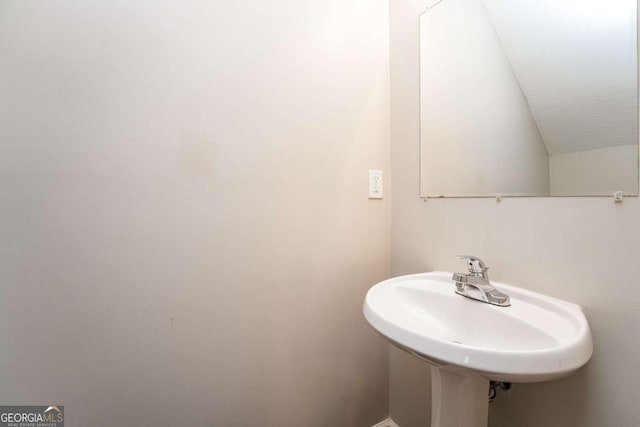 bathroom featuring a textured ceiling and sink