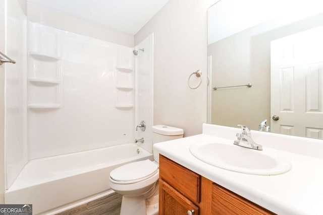 full bathroom with hardwood / wood-style flooring, toilet, vanity, and washtub / shower combination