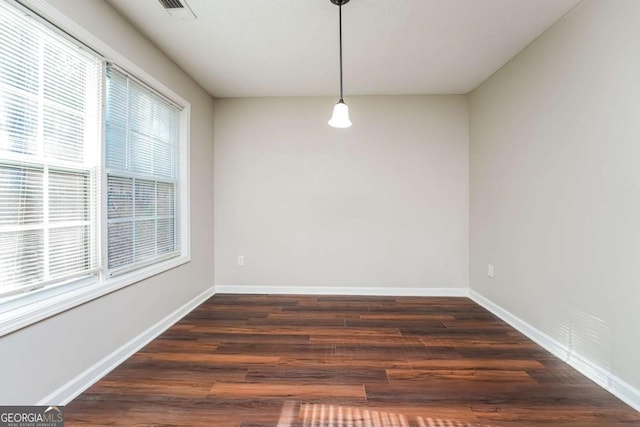 unfurnished dining area with dark hardwood / wood-style flooring