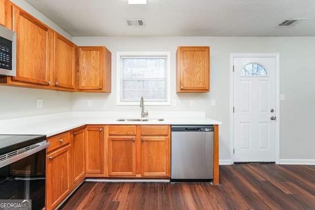 kitchen with black / electric stove, dishwasher, dark hardwood / wood-style floors, and sink