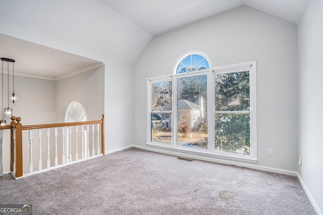 unfurnished room featuring ornamental molding, vaulted ceiling, and carpet