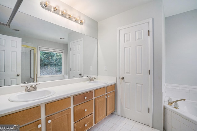 bathroom with tile patterned flooring, independent shower and bath, and vanity