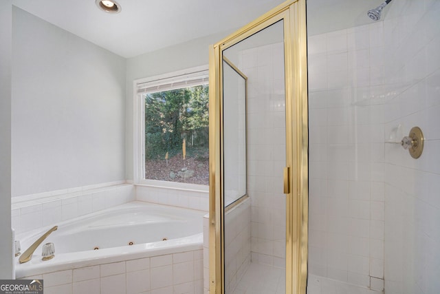 bathroom featuring separate shower and tub