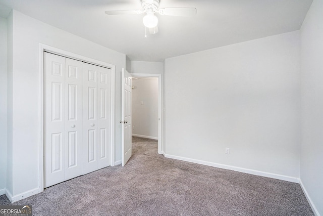 unfurnished bedroom with ceiling fan, a closet, and light carpet