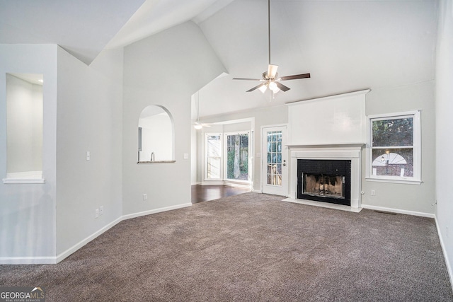 unfurnished living room with lofted ceiling, carpet floors, and ceiling fan