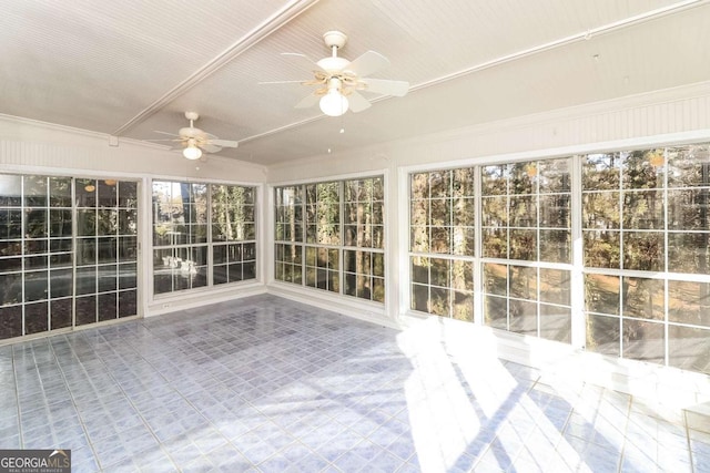 unfurnished sunroom featuring ceiling fan