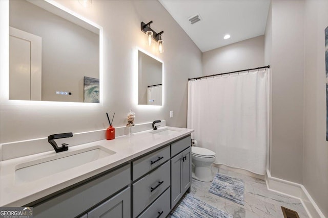 bathroom with walk in shower, vanity, and toilet