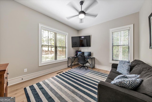 office area featuring a wealth of natural light, ceiling fan, and light hardwood / wood-style flooring