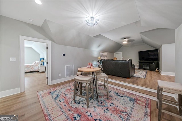 dining area with light hardwood / wood-style floors and lofted ceiling