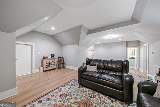 living room with lofted ceiling and light hardwood / wood-style flooring