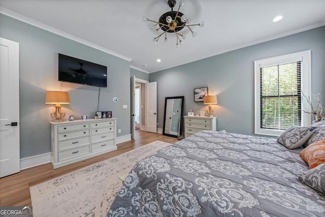 bedroom with light wood-type flooring and crown molding