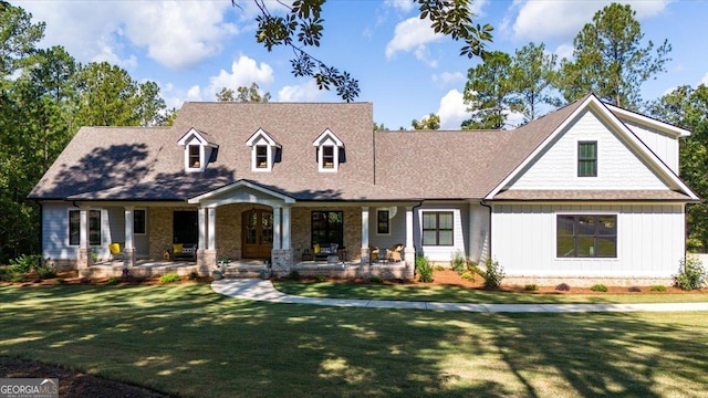 cape cod house with a front lawn and covered porch