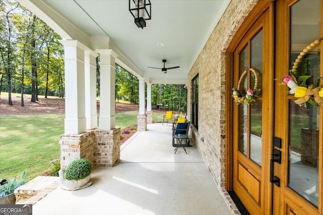 view of patio featuring ceiling fan and a porch