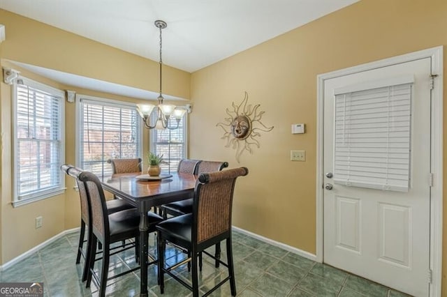 dining space with baseboards, a notable chandelier, and a healthy amount of sunlight