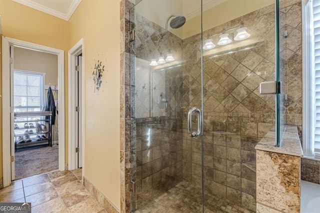 bathroom with crown molding and a stall shower