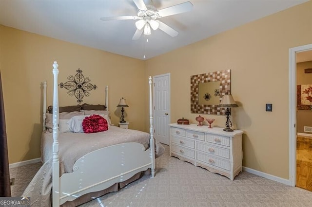 bedroom with visible vents, light carpet, baseboards, and ceiling fan