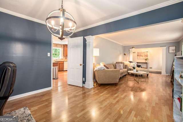 living room with ornate columns, crown molding, light hardwood / wood-style flooring, and a notable chandelier