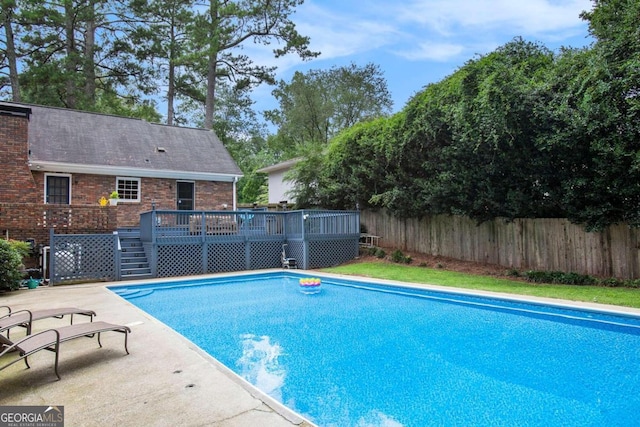 view of swimming pool with a deck