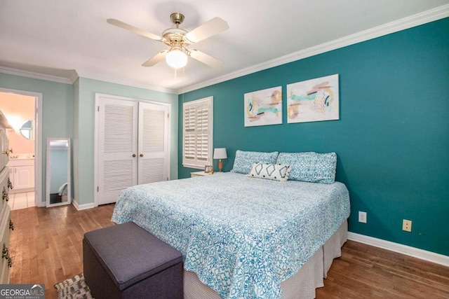 bedroom featuring ornamental molding, ceiling fan, hardwood / wood-style flooring, connected bathroom, and a closet