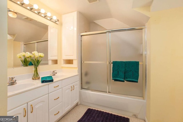 bathroom featuring vanity and enclosed tub / shower combo