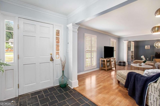 entryway with decorative columns, crown molding, and dark hardwood / wood-style flooring