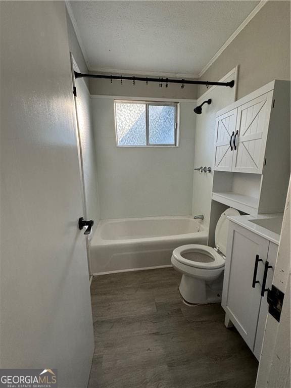 full bathroom with vanity, hardwood / wood-style floors, a textured ceiling, and toilet