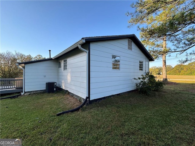 view of home's exterior with a lawn, a deck, and central air condition unit