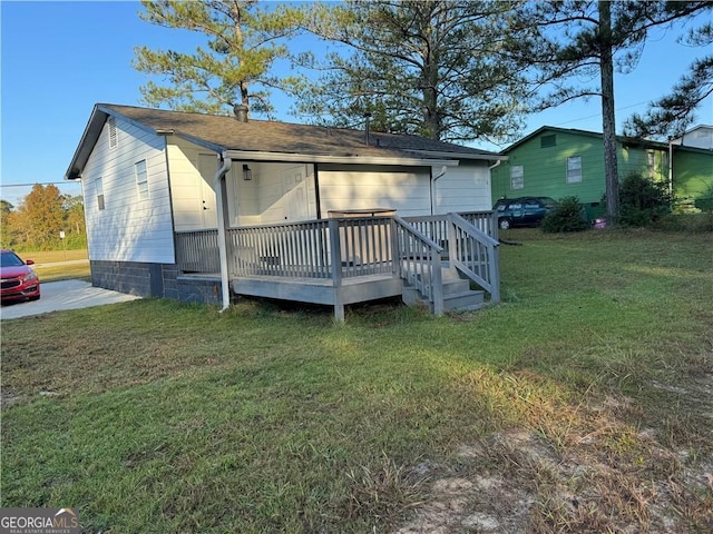 back of property featuring a deck and a yard