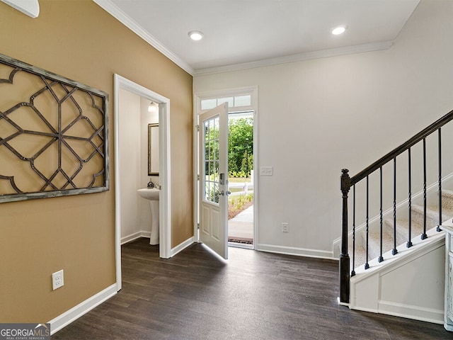 entrance foyer with dark wood-type flooring and ornamental molding