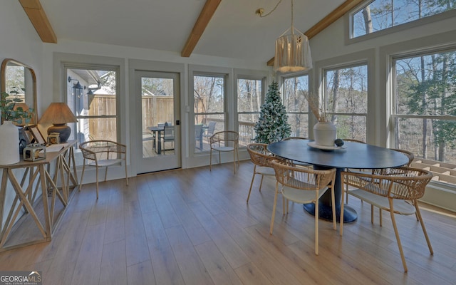 sunroom / solarium featuring vaulted ceiling with beams and wood finished floors