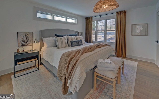 bedroom featuring wood finished floors and baseboards