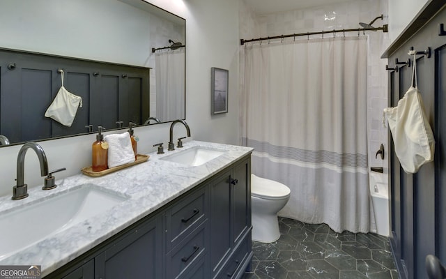bathroom featuring shower / tub combo, toilet, a sink, and double vanity