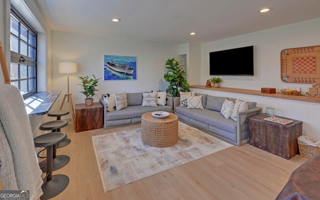 living area with wood finished floors and recessed lighting
