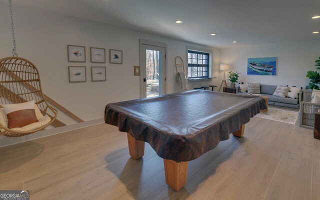 game room with light hardwood / wood-style flooring and pool table