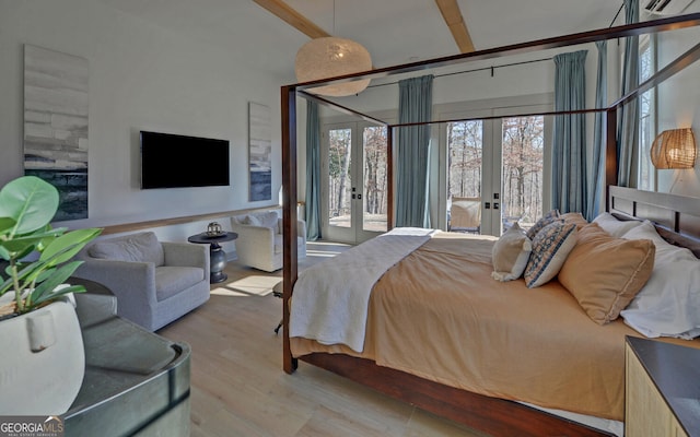 bedroom with french doors, wood finished floors, and access to outside