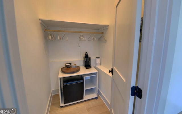 interior space with baseboards and light wood finished floors