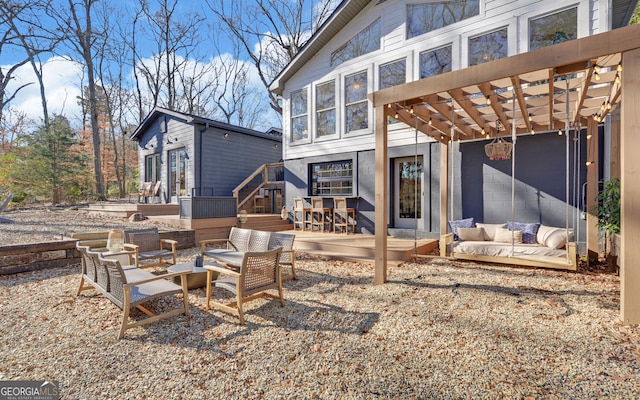 back of house featuring a pergola, an outdoor hangout area, and a deck