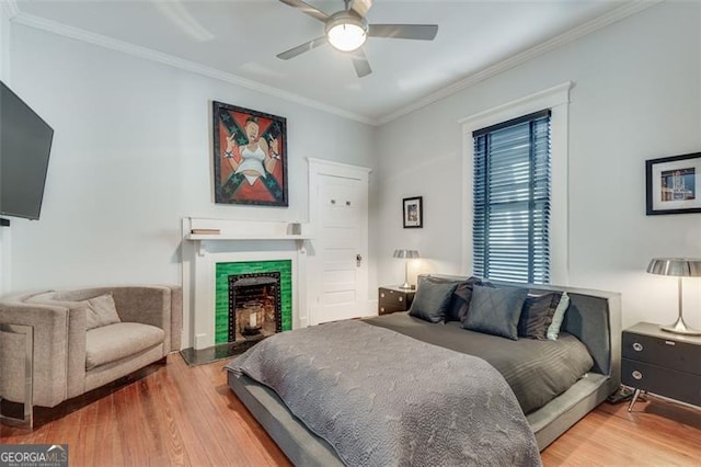 bedroom featuring hardwood / wood-style floors, ceiling fan, and ornamental molding